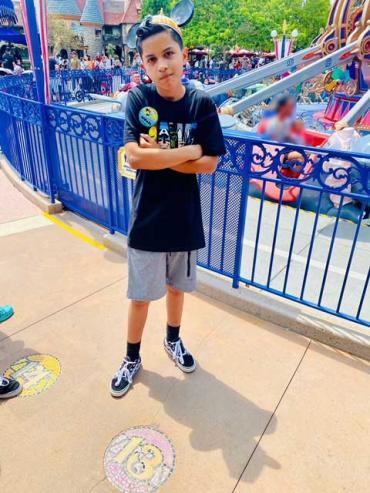 Noah at Disney wearing Mickey ears