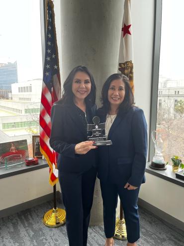 California Assemblymember Blanca Rubio receiving puzzle piece shaped Public Service Award