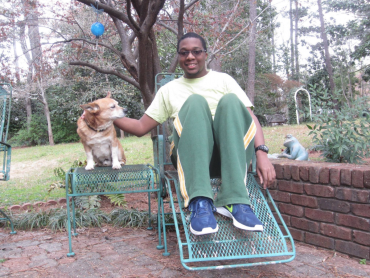 Ryan Lee sitting outside with a dog