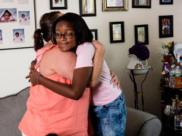 A person hugging another person