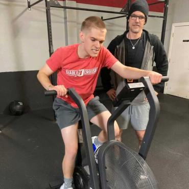 a father and son working out on a stationary bike