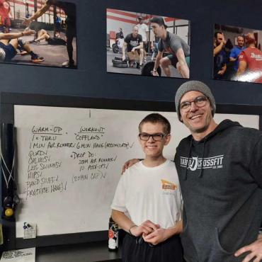 a proud father and autistic son after a CrossFit workout