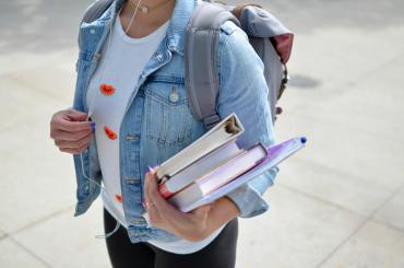 Middle school student with books and backpack