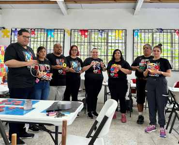 group of people holding up art and crafts they made