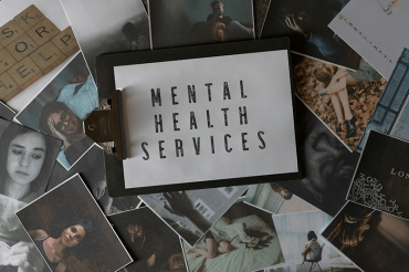 magazine pages surrounding a sign for mental health services