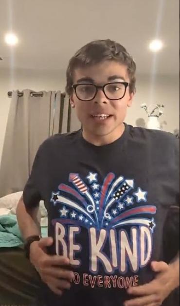 man in glasses wearing a shirt that says Be Kind to Everyone