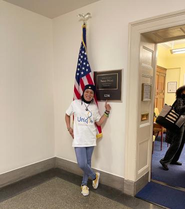 Saida M standing in front of Nancy Pelosi's office sign in DC