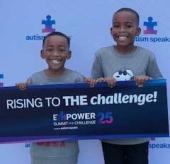 2 little boys holding up an Autism Speaks Empower Summit and Challenge sign