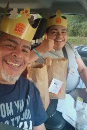 Juan and Guarionex sitting in car eating Burger King
